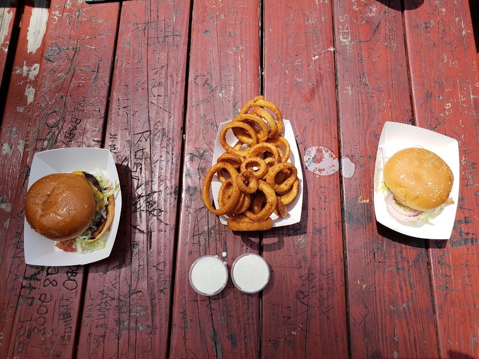 Menu board for burgers, sandwiches, and hot dogs.